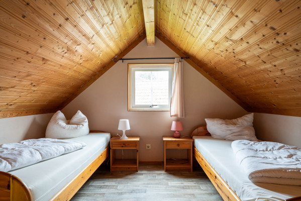 Gemütliches Doppelzimmer mit Holzdach und zwei Betten im Campingplatz Baltic Freizeit in Markgrafenheide.